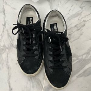Golden goose super star in black nappa with black star and glitter heel tab.